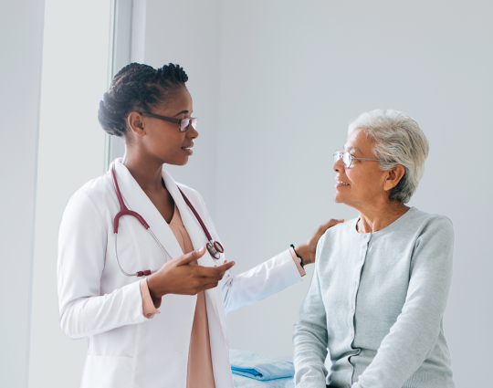 Picture: Female doctor and patient smiling while talking