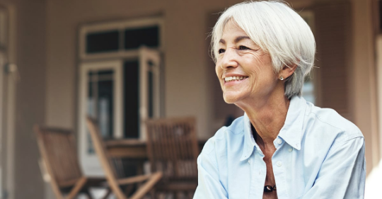 Picture: Smiling woman sitting on porch
